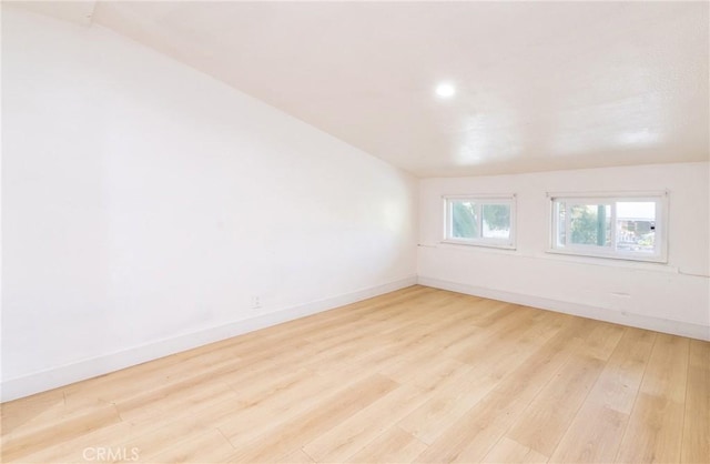 spare room with light wood-style floors and baseboards
