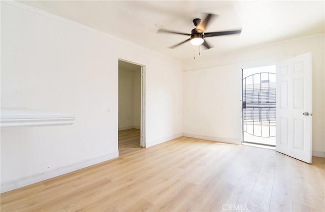 empty room with light wood-type flooring, baseboards, and a ceiling fan