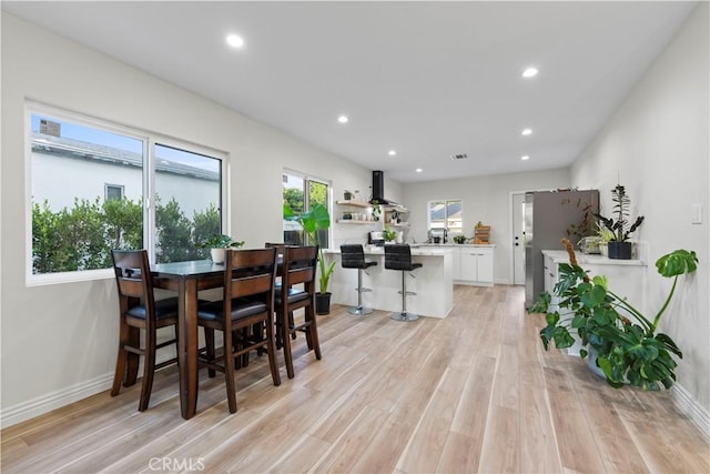 dining area featuring light wood-type flooring, visible vents, baseboards, and recessed lighting