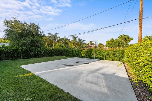 view of patio / terrace with fence and basketball hoop