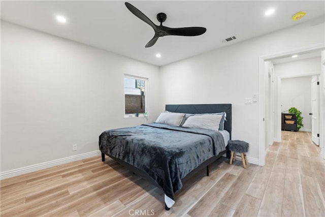 bedroom with baseboards, visible vents, a ceiling fan, light wood-style floors, and recessed lighting