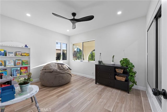 interior space featuring ceiling fan, light wood-type flooring, baseboards, and recessed lighting