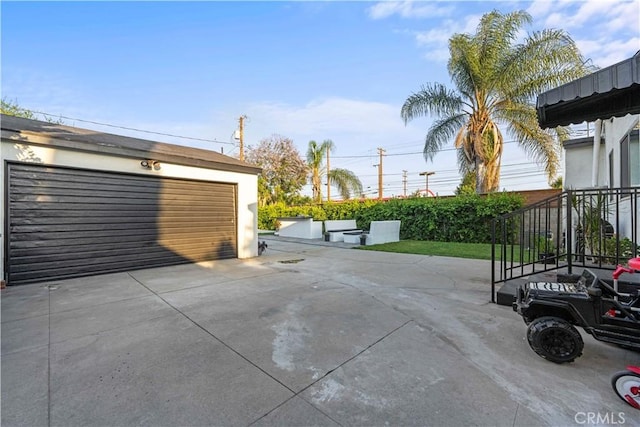 view of patio / terrace featuring an outbuilding and a garage