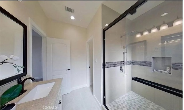 bathroom featuring a stall shower, vanity, visible vents, and recessed lighting