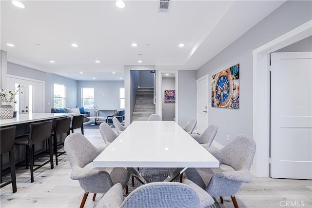 dining space with stairs, visible vents, light wood-style flooring, and recessed lighting