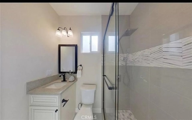 full bathroom featuring toilet, a walk in shower, and vanity