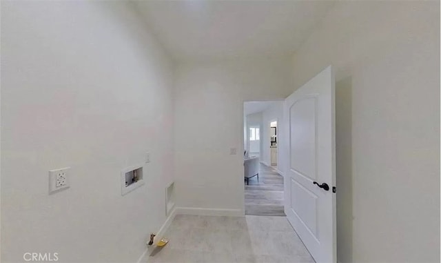 clothes washing area featuring washer hookup, laundry area, visible vents, and baseboards