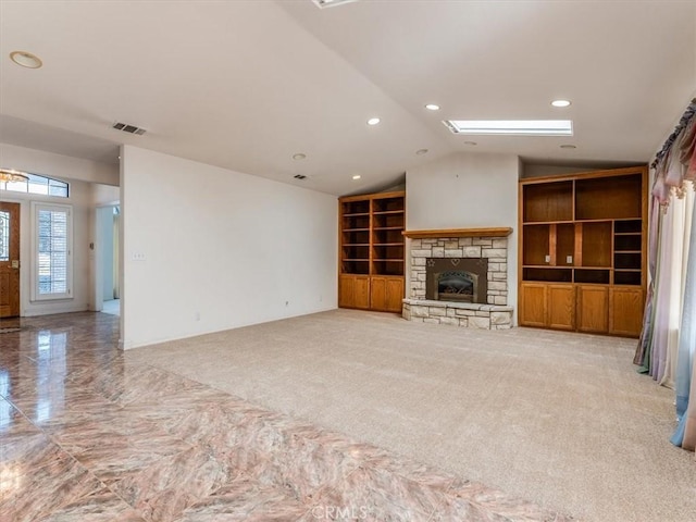 unfurnished living room with built in shelves, recessed lighting, a fireplace, visible vents, and vaulted ceiling