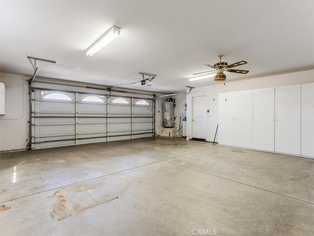 garage featuring water heater and a garage door opener