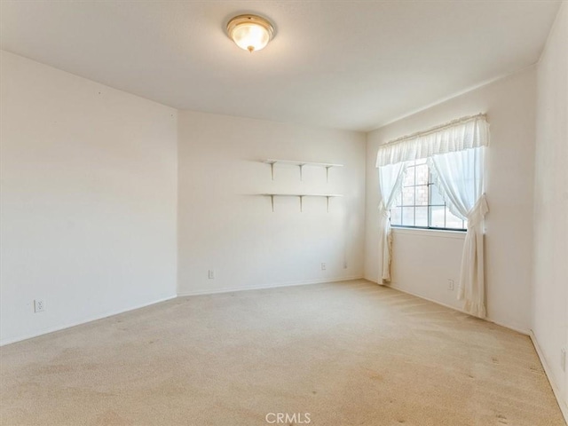 empty room featuring light carpet