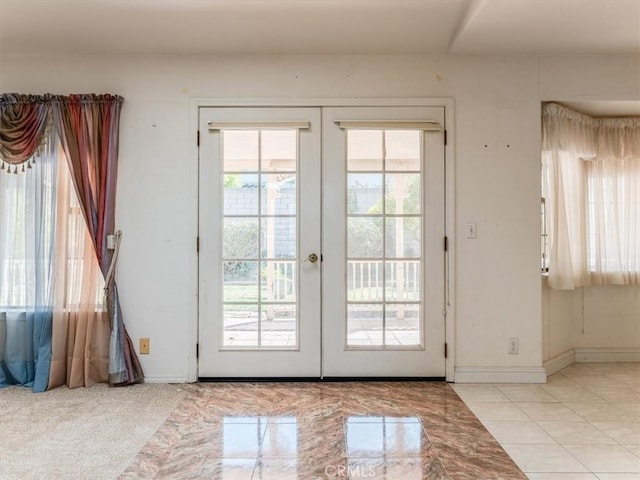 doorway to outside featuring french doors and baseboards