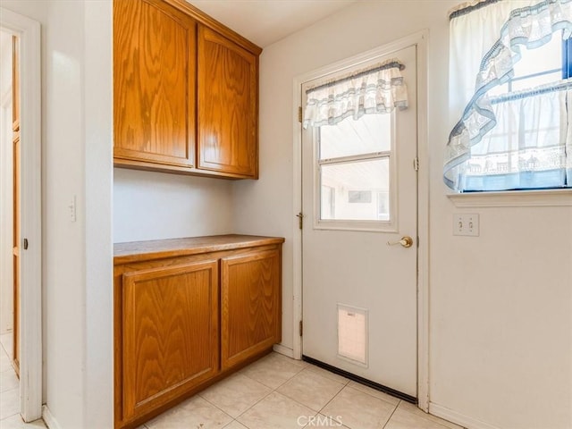 entryway featuring a wealth of natural light and light tile patterned flooring