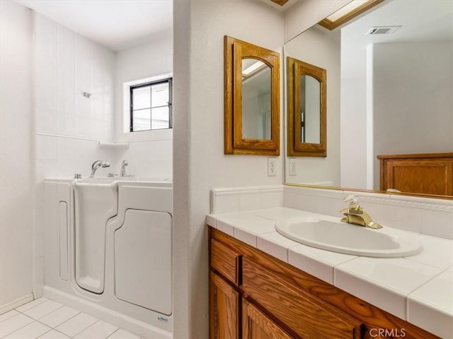 bathroom featuring vanity, visible vents, and tile patterned floors