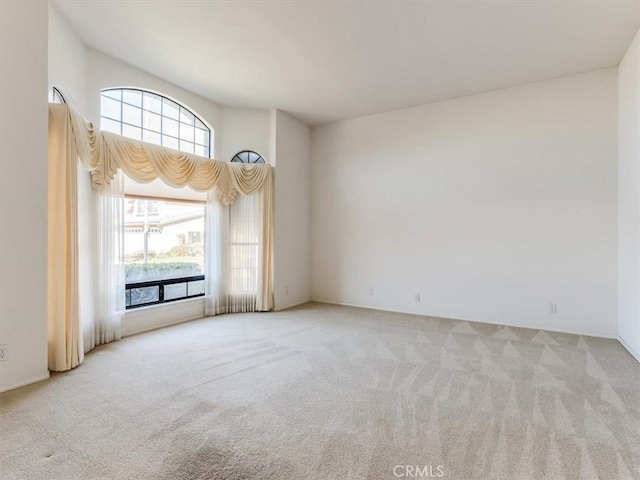 unfurnished room featuring light colored carpet