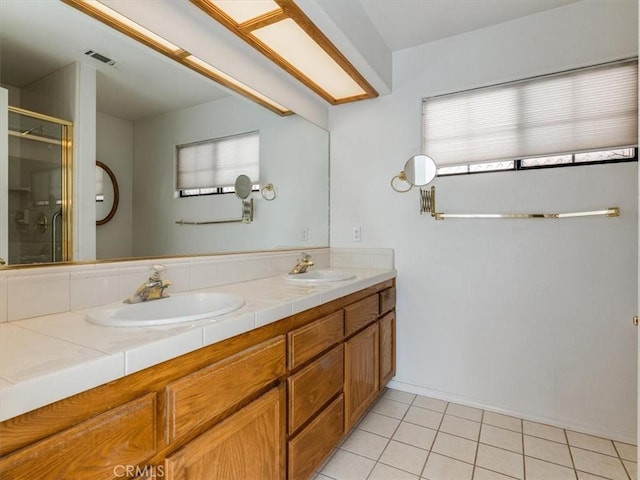 full bath featuring tile patterned flooring, visible vents, a sink, and double vanity