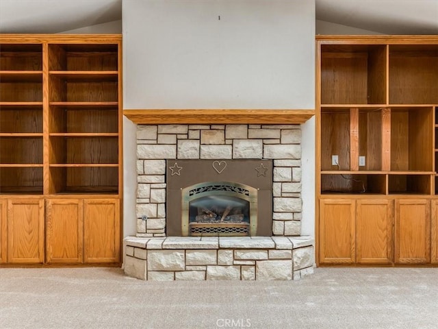 unfurnished living room featuring lofted ceiling, a stone fireplace, and light colored carpet