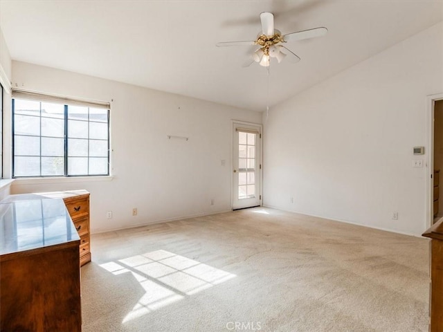 unfurnished room featuring light carpet, lofted ceiling, and a ceiling fan