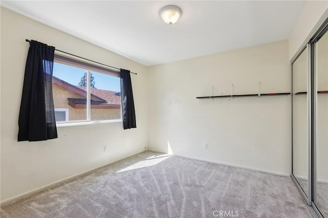 spare room featuring light colored carpet