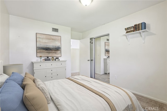 bedroom featuring a closet, baseboards, visible vents, and carpet flooring