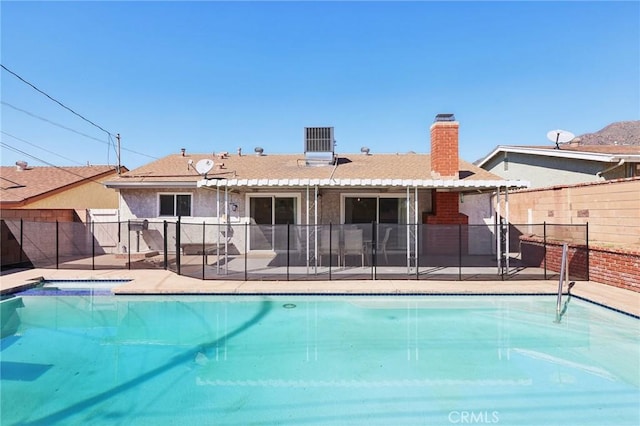 view of pool featuring fence, a fenced in pool, and a patio