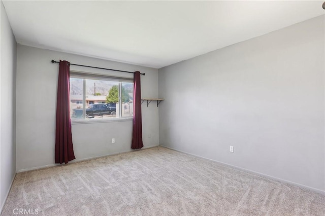 spare room with light colored carpet