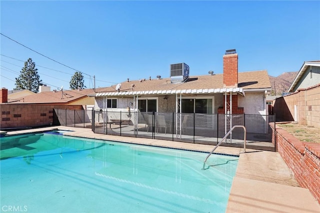 view of pool featuring a fenced in pool, cooling unit, a patio area, and a fenced backyard