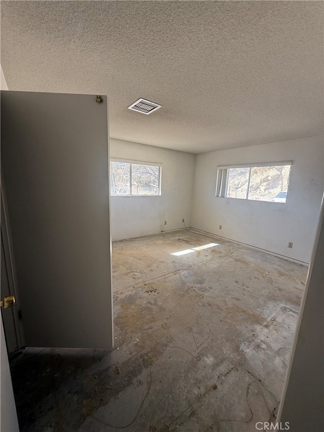 spare room with visible vents and a textured ceiling