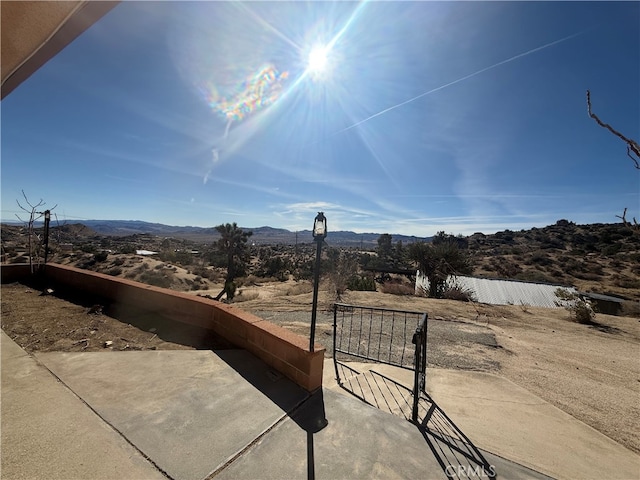 exterior space featuring a mountain view and fence