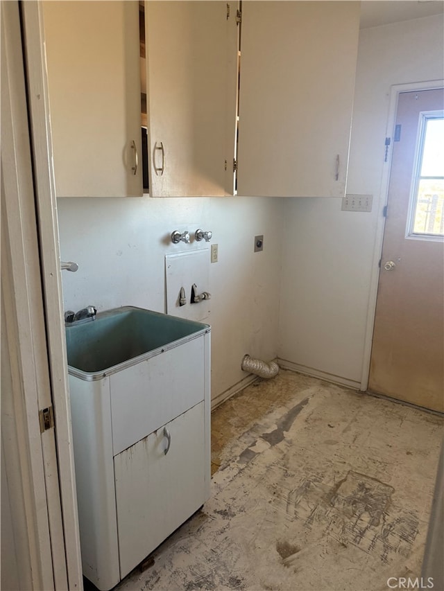 laundry room with a sink, cabinet space, and hookup for an electric dryer