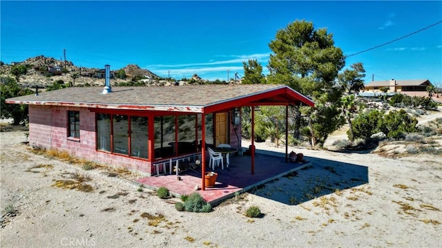 exterior space featuring a sunroom