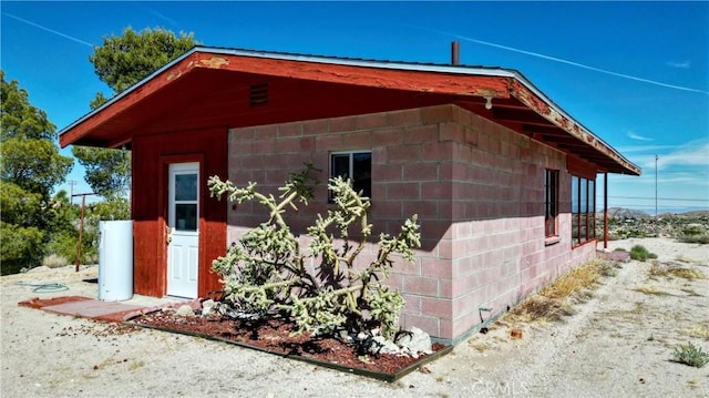 view of property exterior featuring concrete block siding