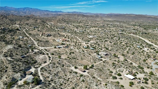 birds eye view of property featuring a desert view and a mountain view