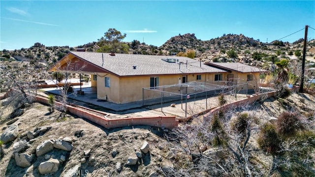 rear view of property with stucco siding