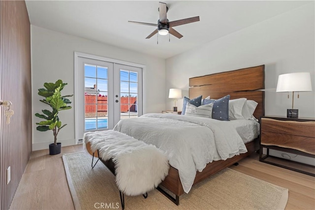 bedroom with access to exterior, light wood-style flooring, ceiling fan, and french doors