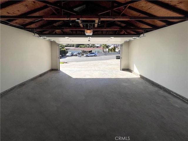 garage featuring baseboards and a garage door opener