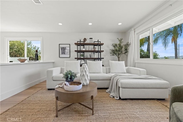 sitting room with baseboards, wood finished floors, visible vents, and recessed lighting