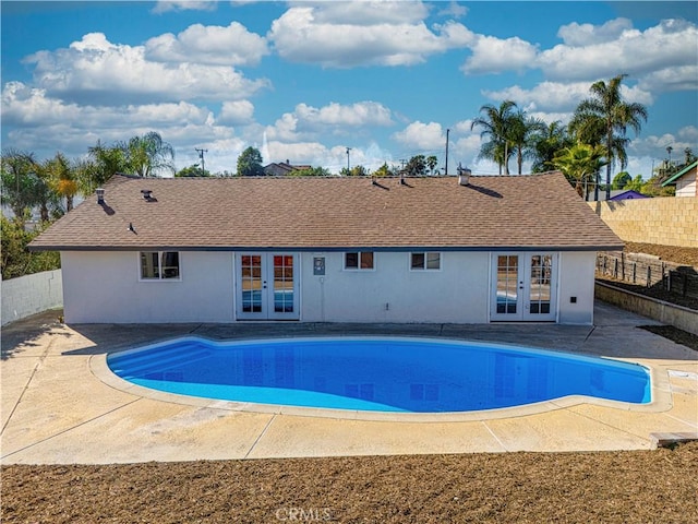 view of swimming pool with a fenced in pool, fence, a patio, and french doors