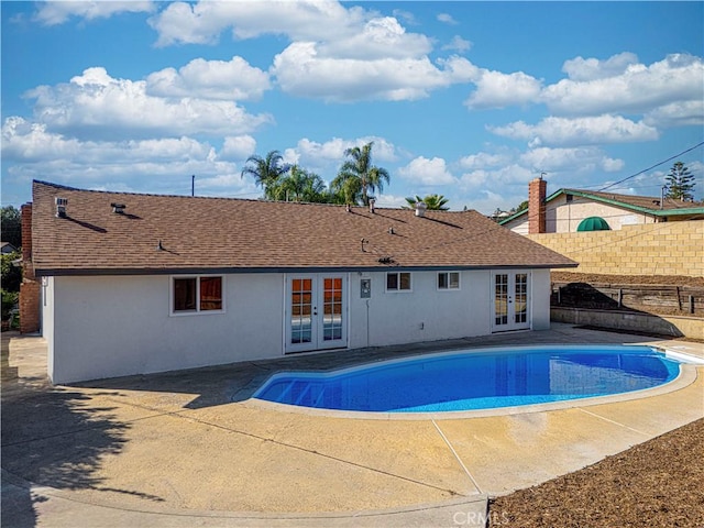 view of swimming pool with a patio area, a fenced in pool, and french doors