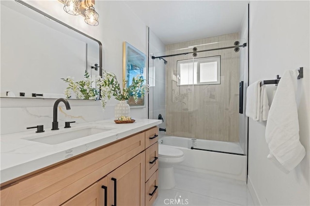 full bathroom with toilet, bath / shower combo with glass door, and vanity