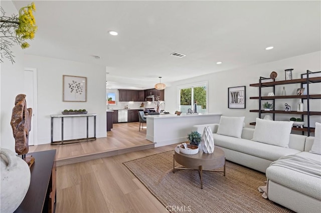 living area featuring recessed lighting, visible vents, and light wood-style floors