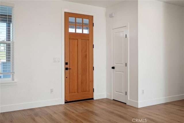 entrance foyer featuring baseboards and light wood-style floors