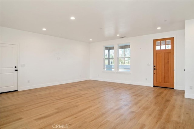 entryway featuring baseboards, light wood-type flooring, and recessed lighting