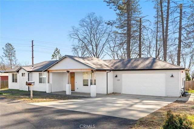 ranch-style house featuring a porch, roof with shingles, driveway, and an attached garage