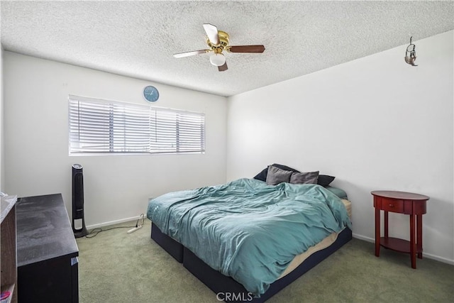 bedroom with a textured ceiling, carpet floors, a ceiling fan, and baseboards