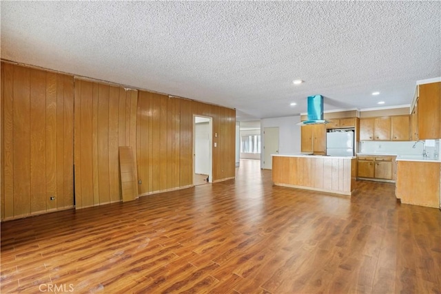 interior space featuring light wood-type flooring and a textured ceiling