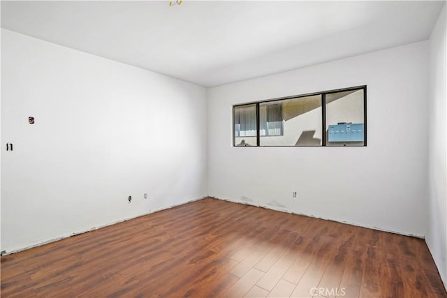 empty room with dark wood-style flooring