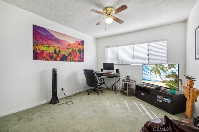 office space with carpet flooring, ceiling fan, a textured ceiling, and baseboards