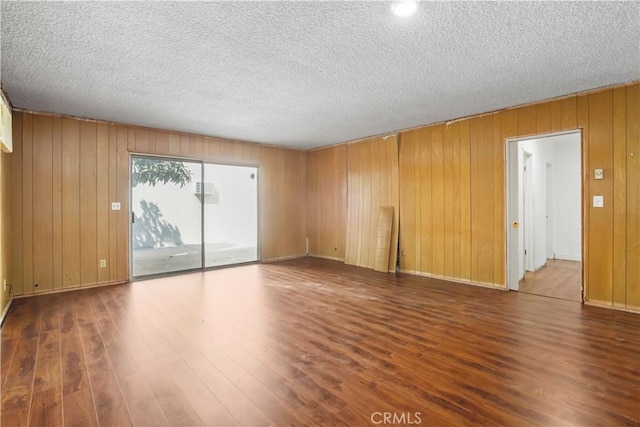 unfurnished room featuring dark wood-style floors and a textured ceiling