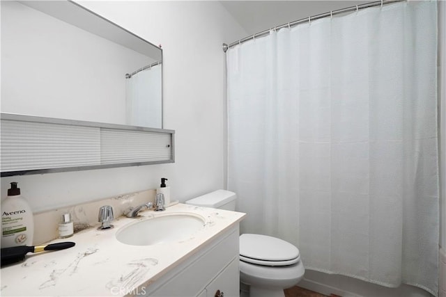 bathroom featuring vanity and toilet