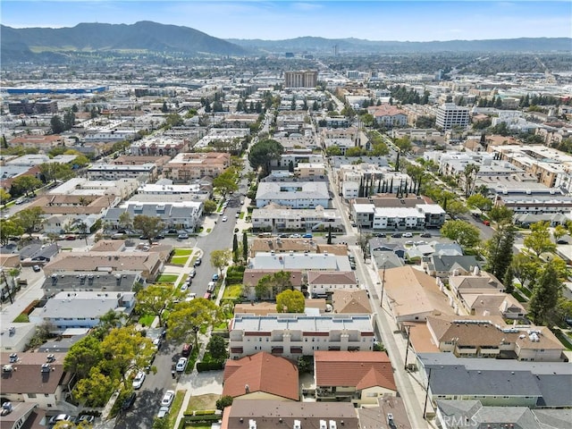 drone / aerial view featuring a view of city, a mountain view, and a residential view